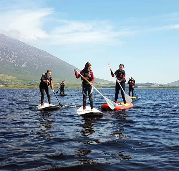 group of people doing sup in achill island