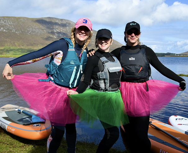 group of girls doing sup in funny outfit